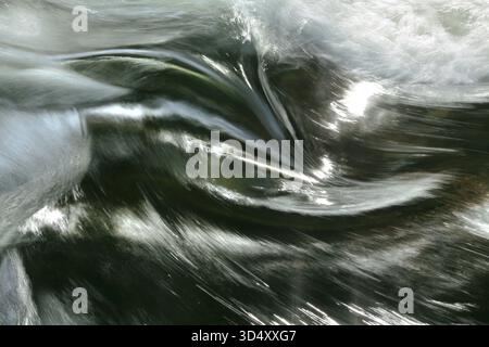 River water plunging down and swirling over rocks in North Wales. Stock Photo