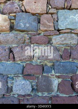 Rustic Stone Wall Texture with Mixed Volcanic Rocks Stock Photo