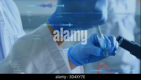 Pipetting hand in lab coat, nitrile gloves moving liquid into vial at lab bench, data overlay Stock Photo