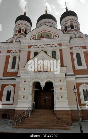 Entrance and facade of Alexander Nevsky Cathedral, Russian Orthodox church, with steps, arches, and mosaic in Tallinn, Estonia, under clouds, detail. Stock Photo