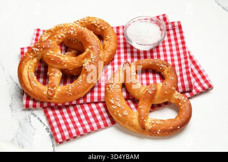 Napkin and tasty pretzels on marble background, closeup Stock Photo