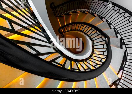 Spiral staircase with ornate metal railings, leading up to a hexagonal ...