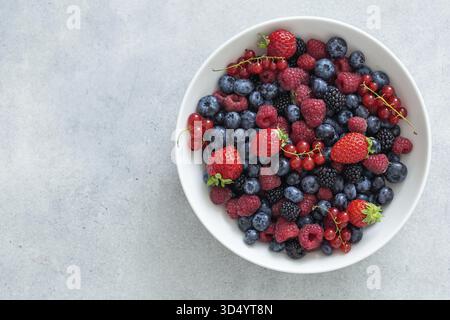 Food, Fresh summer organic berries in white bowl, healthy food concept, top view, copy space Stock Photo