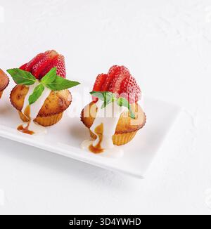 Food, Vanilla cupcakes with strawberry on white plate Stock Photo