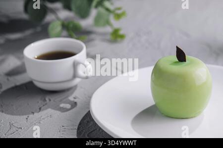Food, Green apple shaped mousse cake and cup of coffee Stock Photo