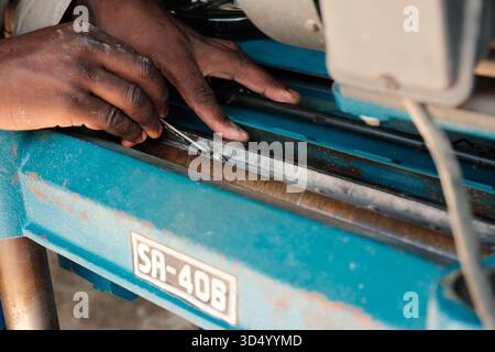 Hands Adjusting Blade on Industrial Woodworking Machine Stock Photo
