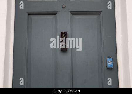 Grey front door with video doorbell camera. Residential house security Stock Photo