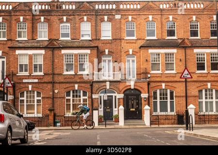 LONDON - OCTOBER 21, 2025: Victorian Terraced Houses on Palliser Road Near Barons Court Station, West London Residences Stock Photo