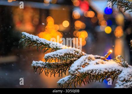 A magical scene at the Zurich Christmas Market in Switzerland, with twinkling lights and snowfall creating a winter wonderland, defocused bokeh Stock Photo