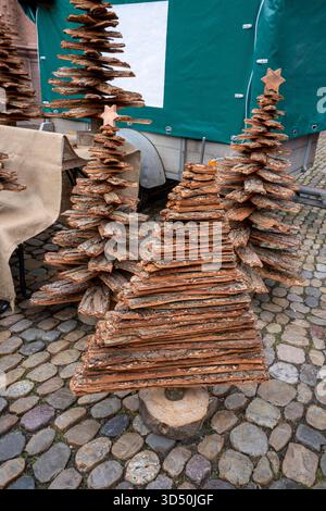 Handmade Christmas trees made from tree bark at a street market Stock Photo
