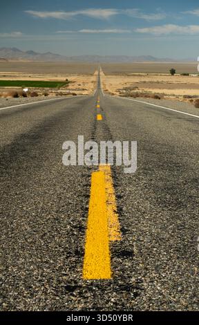 Vertical view of a straight section of asphalt Nevada highway 140 stretching to the horizon in a deserted perspective Stock Photo