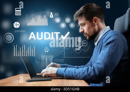 Man working on financial audit with digital graphs in a modern office setting Stock Photo