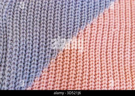 Close-up macro photo of knitted fabric made of pink and purple yarn. Stock Photo