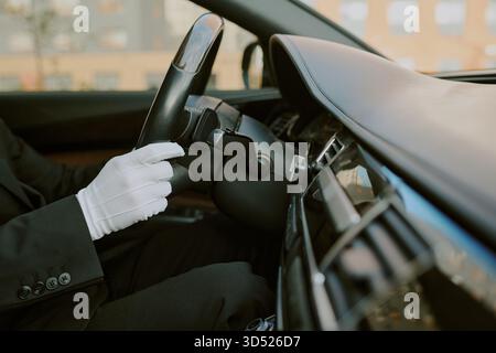 Middle Aged Man Wearing Gloves Driving Luxury Car Interior Stock Photo