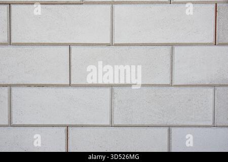 A uniform pattern of rectangular blocks shows clean lines and consistent texture under even lighting. selective focus Stock Photo