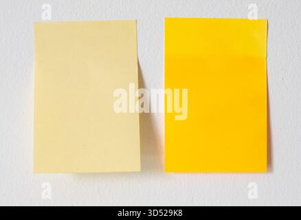 Two sticky notes on white wall Stock Photo