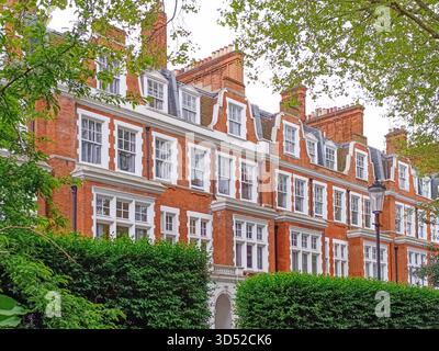 Victorian red brick townhouses in London with sash windows, gables and chimneys Stock Photo