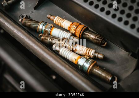 Worn auto spark plugs indicating vehicle maintenance and engine repair Stock Photo