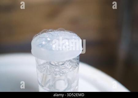 Foam bubbles in the valve when brewing beer. Stock Photo