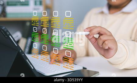 Child using stylus on tablet with digital checklist and task management interface, representing productivity, online learning, organization and modern Stock Photo