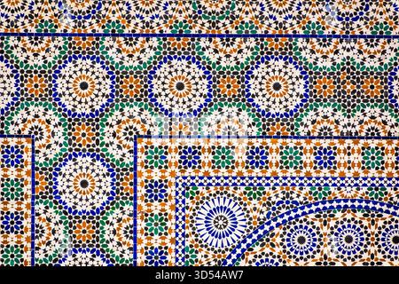 Casablanca, Morocco – Close-up of a colorful traditional Moroccan zellige mosaic tile pattern featuring geometric shapes in blue, green, brown, and wh Stock Photo