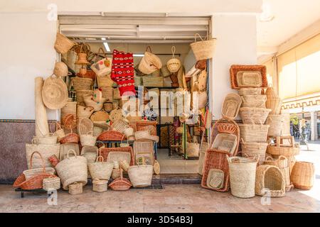 Rabat, Morocco – A colorful display of handwoven baskets, mats, and trays made from natural fibers, showcased outside a traditional artisan shop in th Stock Photo