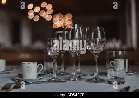 Majestic medieval castle banquet hall with long wooden tables, chandeliers, and stone walls illuminated by warm candlelight, evoking the atmosphere of Stock Photo