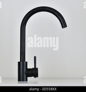 Black single-lever mixer tap on light background Stock Photo