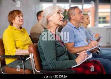 Group of mature students attending lecture in college Stock Photo