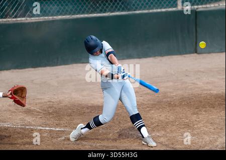 A Baseball Player Is Captured Swinging the Bat In Full Motion Action Stock Photo