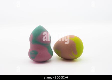 Multicolored beauty blenders. Two sponges for applying makeup on white background Stock Photo