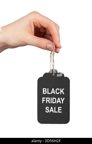 Black Friday tag held by hand. Black price-off label with twine loop, isolated on white background, designed for retail, shopping, fashion, and market Stock Photo