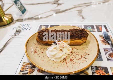 BAKU, AZERBAIJAN. MIX POINT. The dessert in the image is most likely an eclair. It is a long, baked pastry made from choux dough, filled with a cream, Stock Photo