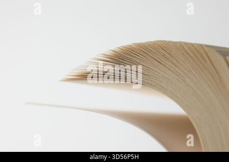 A book with pages flipping over in warm light Stock Photo