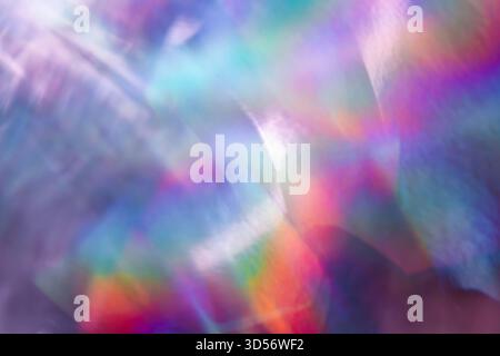 Soft colorful abstract background with blurred light reflections in purple, blue, and pink tones, creating a dreamy gradient texture. Stock Photo