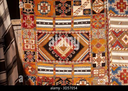 Moroccan carpets with oriental ornaments for sale on a street shop in Kasbah Ait Ben Haddou near Ouarzazate in the Atlas Mountains of Morocco. Stock Photo
