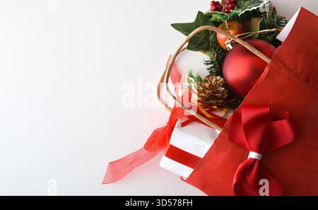 Christmas gift concept with shopping bag with gift and decoration on white background. Top view. Stock Photo