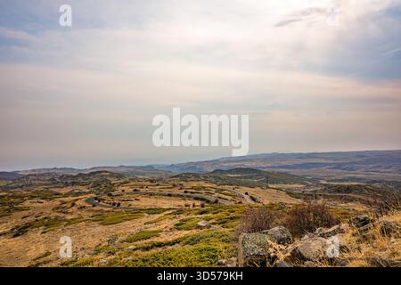 A beautiful landscape with a clear blue sky and a few clouds. The sky is filled with a sense of calmness and serenity Stock Photo