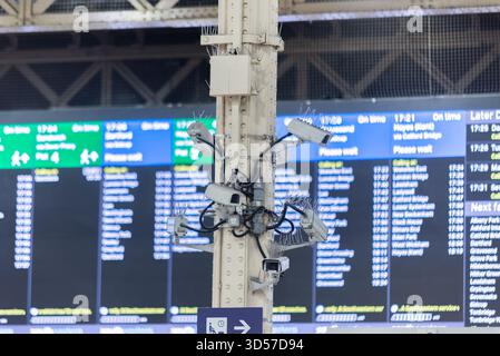 Quantity of CCTV cameras for security at Charing Cross railway station, with destination board. Video surveillance Stock Photo