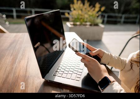Outdoor Work with Smartphone and Laptop Stock Photo
