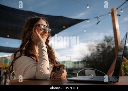 Woman Enjoying Outdoor Workspace with Tech Devices Stock Photo