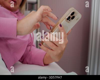 Patient using smartphone in bed Stock Photo
