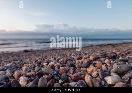 Pebbles on the Shore at Dazendorf Beach, Schleswig Holstein, Germany Stock Photo