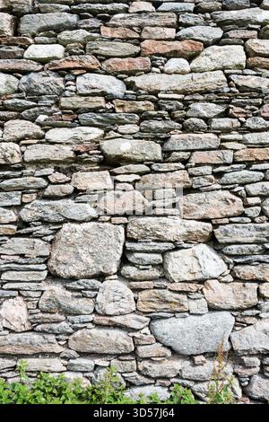 Different sizes of stone blocks in a wall. Stock Photo