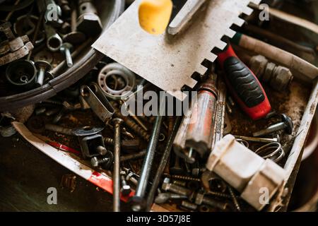 Various tools and hardware scattered in a workshop Stock Photo