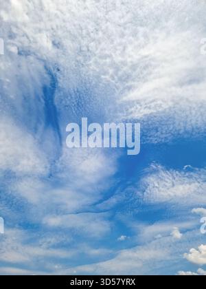 Blue sky with beautiful cirrus clouds as a background. Template, postcard, banner, space for text. Stock Photo