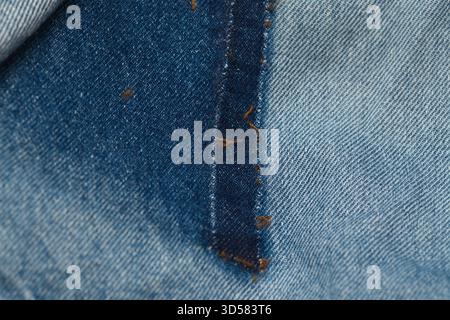 old jeans being taken apart for upcycling, unfaded patches showing Stock Photo