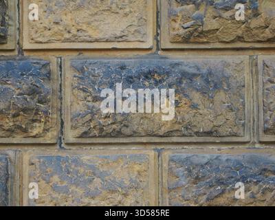 Historic rusticated stone wall with irregular, rough blocks. Close-up. Copyspace. Stock Photo