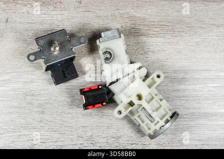 Close-up of an automotive ignition switch with electrical connectors placed on a wooden surface smart fourtwo Stock Photo
