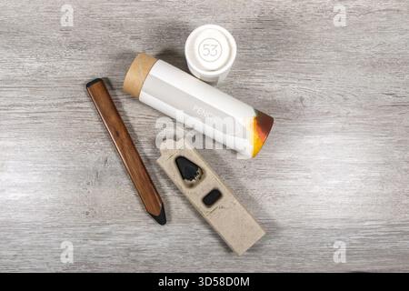 Digital stylus, pencil by 53 with wooden finish for iPad next to branded cylindrical packaging and cap placed on a wooden surface Stock Photo